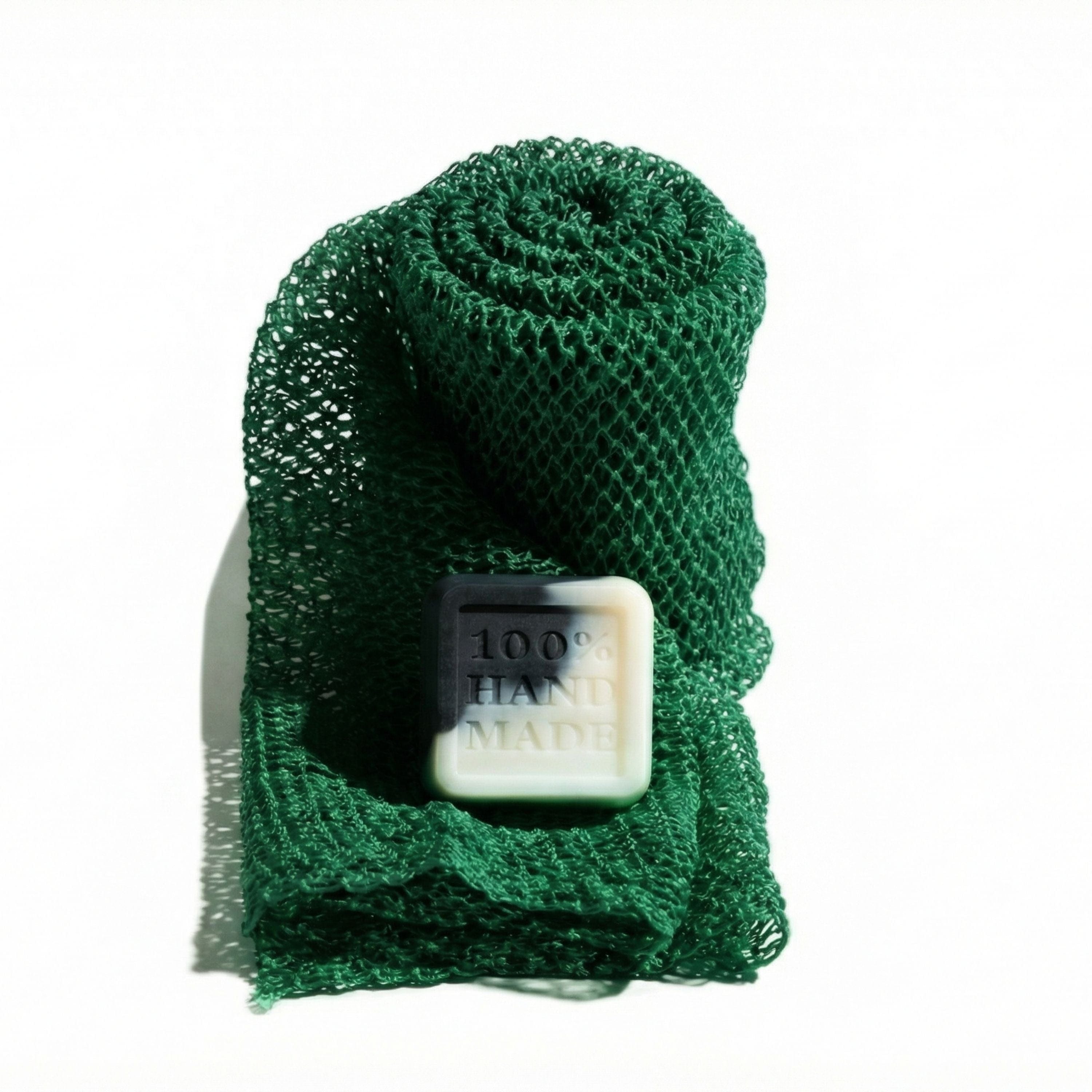 Green mesh Enso Sapo body exfoliator with a 2 oz bestselling Enso bar soap on a white background